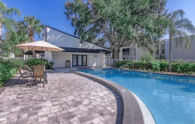 a house with a pool outside of a building