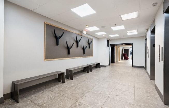 Hallway with bench seating and elevators at Vera Cortez Hill, San Diego, CA