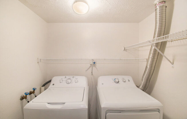 a laundry room with full size washer and a dryer at Canal 2 Apartments, Lansing, Michigan