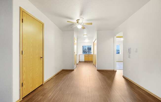 a bedroom with hardwood flooring and a ceiling fan