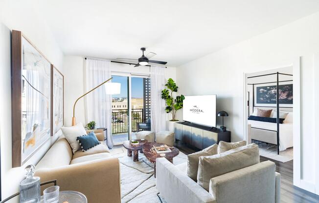 Natural light fills the spacious living area, which opens directly to your private balcony and flows seamlessly into the adjacent bedroom.