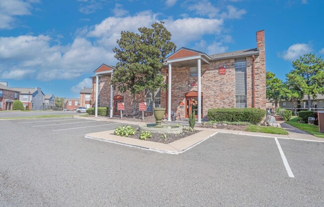 Our leasing office with a red brick facade surrounded by parking at Magnolia apartments in Shreveport, LA