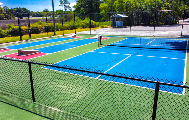 a group of tennis courts on top of a fence