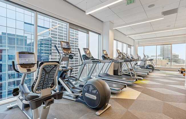 A gym with treadmills, exercise bikes, and elliptical machines.