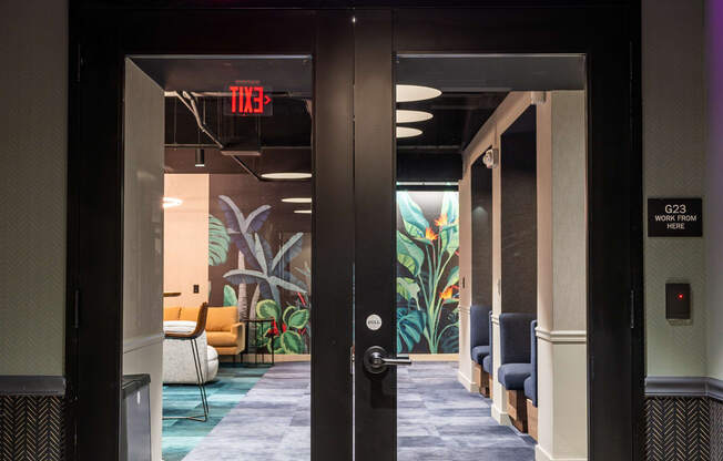 a purple neon sign above a door that reads work from home
