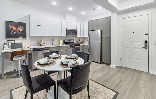 a kitchen and dining room with a table and chairs