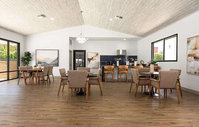 A modern dining room with wooden floors and furniture.