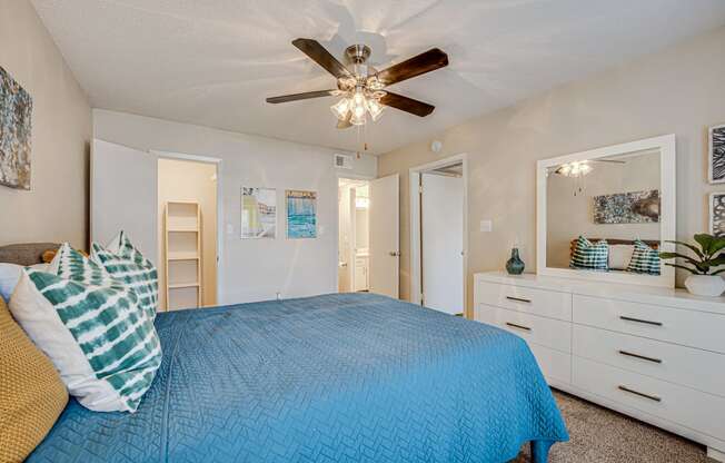 a bedroom with a bed and a ceiling fan