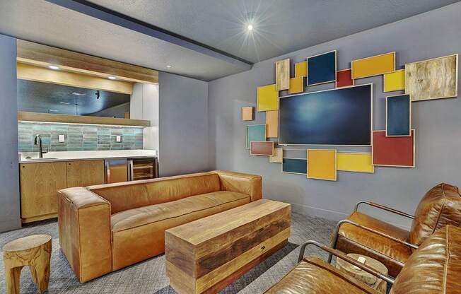 A modern living room with a brown leather couch and a wooden coffee table.