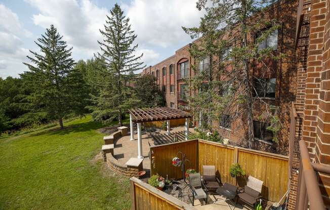 a backyard with a patio and a brick building
