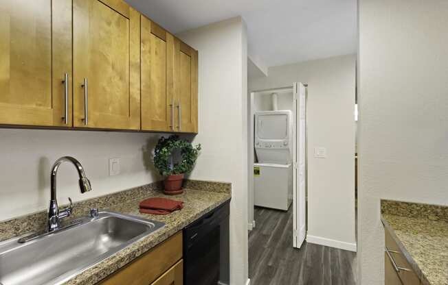 a kitchen with a sink and a washer and dryer