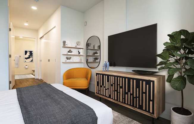 A modern bedroom with a large bed and a flat screen TV.
