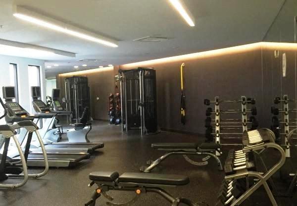 a gym with weights and other equipment on the floor