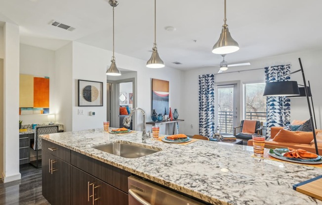 A kitchen with a marble countertop and modern appliances.