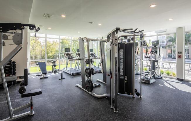 a gym with weights and cardio equipment in a building