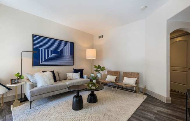 a living room with a couch and chairs and a rug at Mirasol Apartments, Nevada