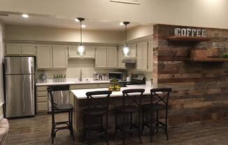 a kitchen with a bar and a table with chairs