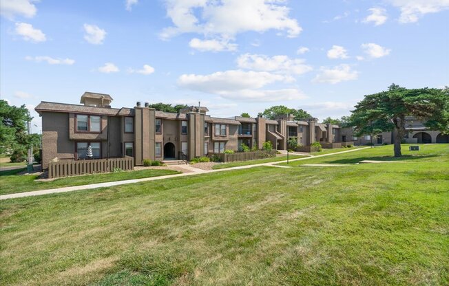 A row of houses with green lawns in front.