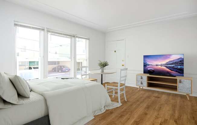 a bedroom with a bed and a tv on a table