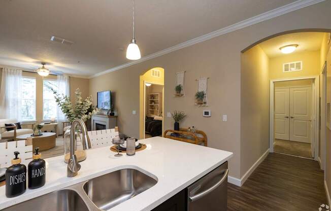 A kitchen with a sink and a counter.