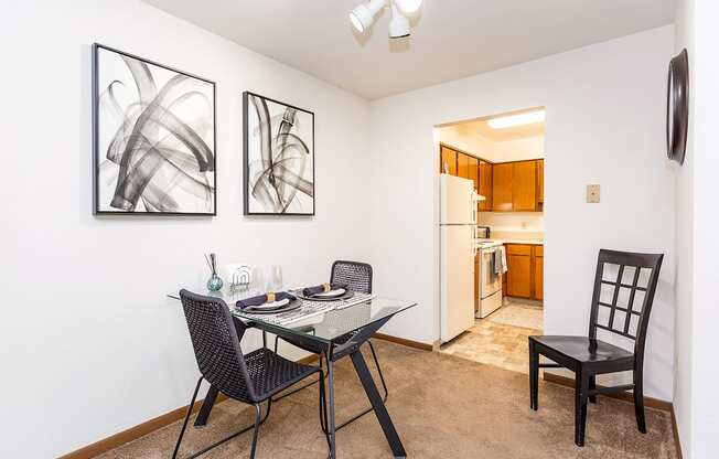 A dining room with a glass table and chairs.