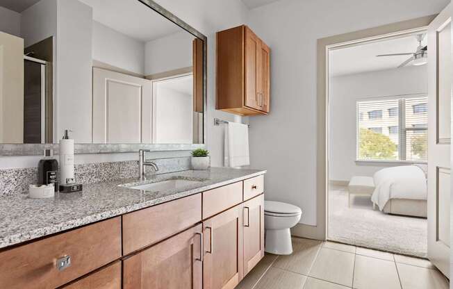 A modern bathroom with a white sink and a mirror.