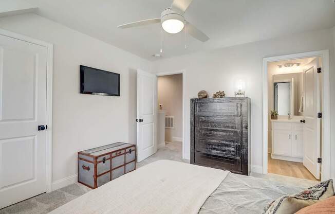 A bedroom with a bed, dresser, and mirror.