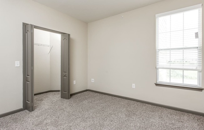 an empty room with a door and a window