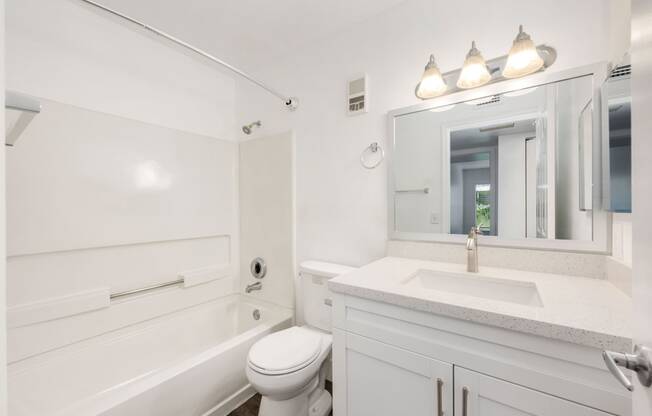 a bathroom with a sink toilet and a bath tub