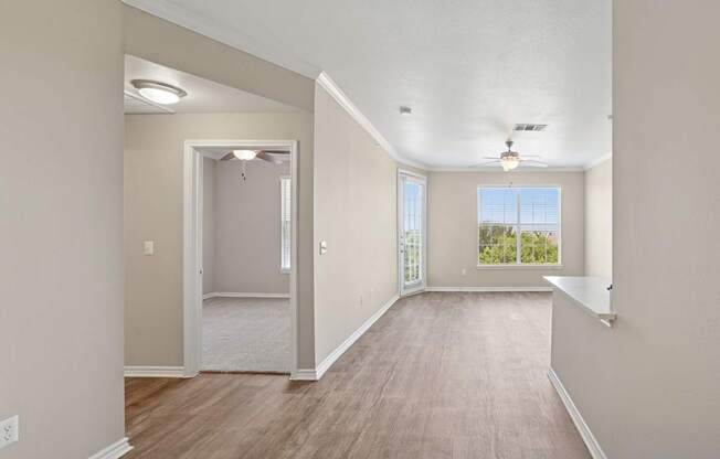 Kenzington living room with a carpeted floor and a ceiling fan at Encore at Buckingham Apartments in Richardson, TX