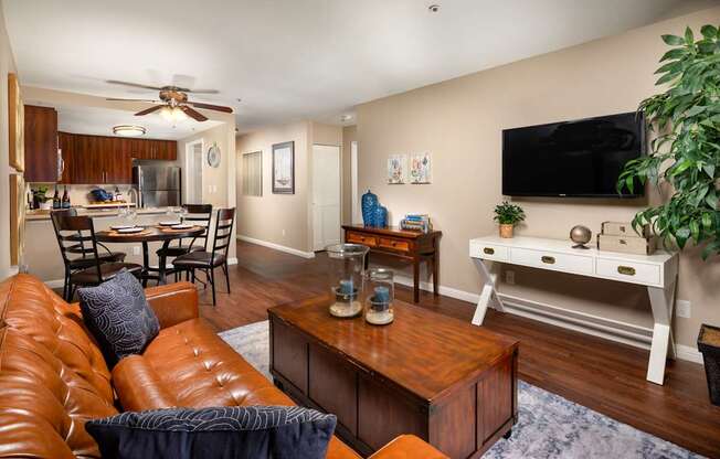 Living room with a leather couch and a tv