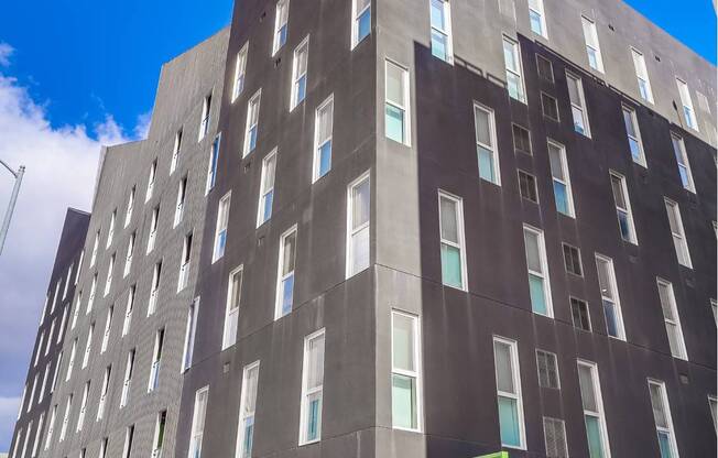 A tall building with a green door and windows.