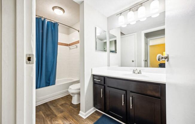 a bathroom with a shower and a sink and a mirror