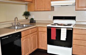 a stove top oven sitting inside of a kitchen