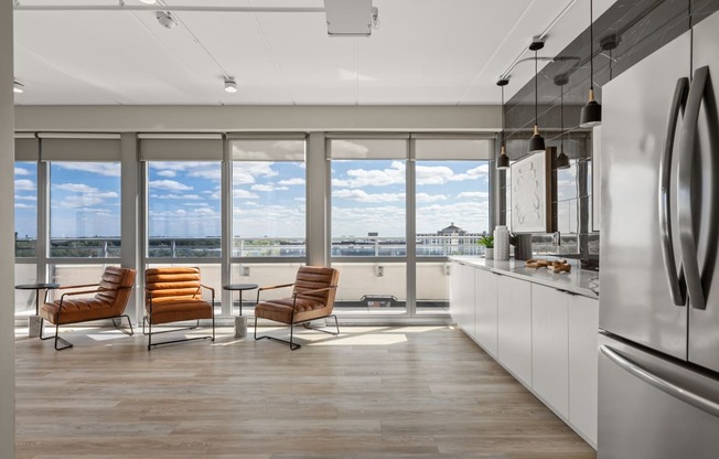 a kitchen and living room with a view of a river and a balcony