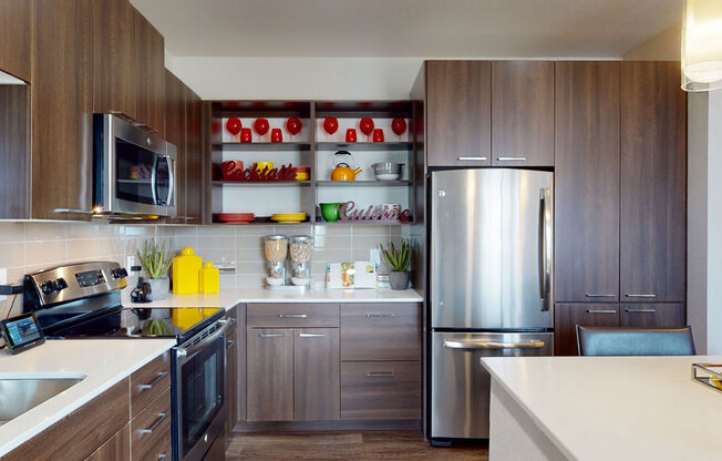 a kitchen with wooden cabinets and a stainless steel refrigerator