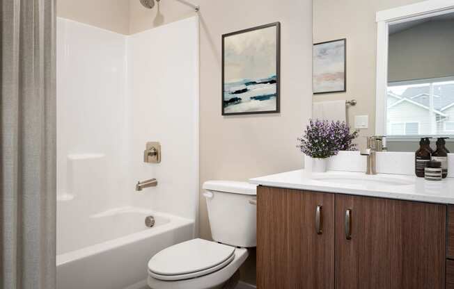 a bathroom with a toilet and a sink and a shower