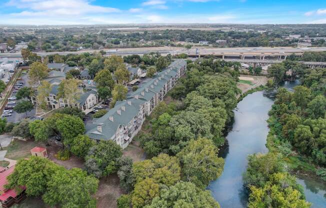 an aerial view of a row of houses next to a river