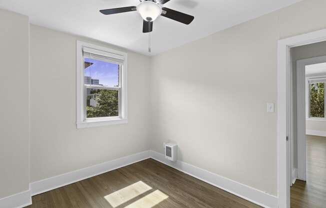 a bedroom with a ceiling fan and hardwood floors at Stockbridge Apartment Homes, Washington, 98101