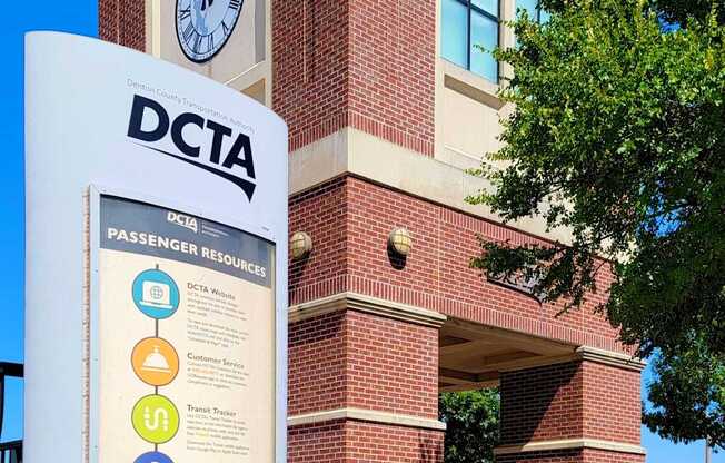 A sign in front of a building with the letters DCTA on it.