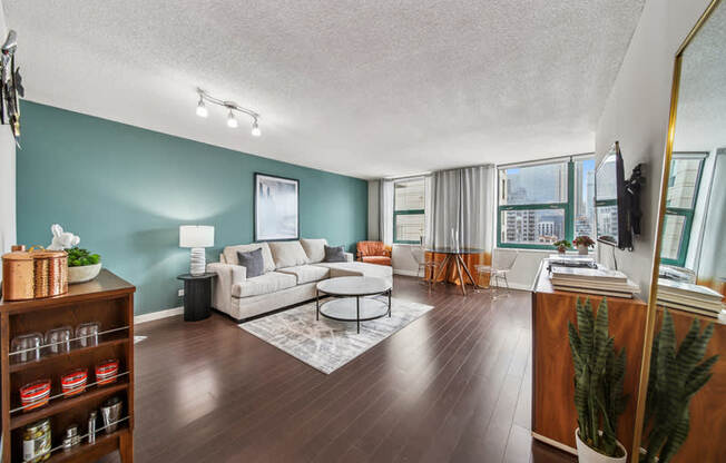 A living room with a grey couch and a coffee table.