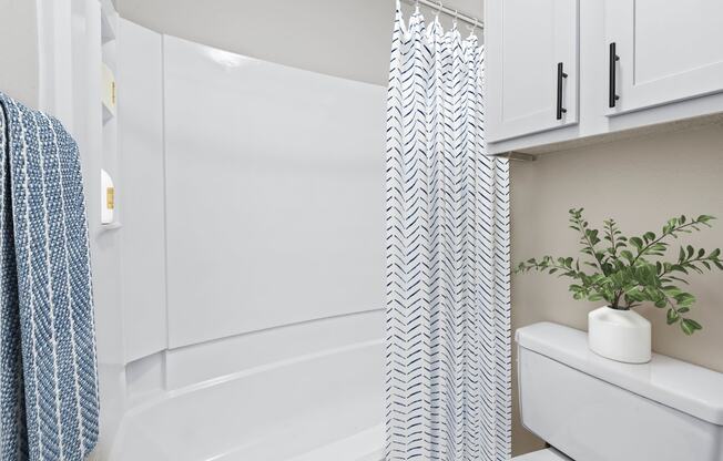 a bathroom with a toilet and a bathtub at Carmel at Deerfield, San Antonio, Texas