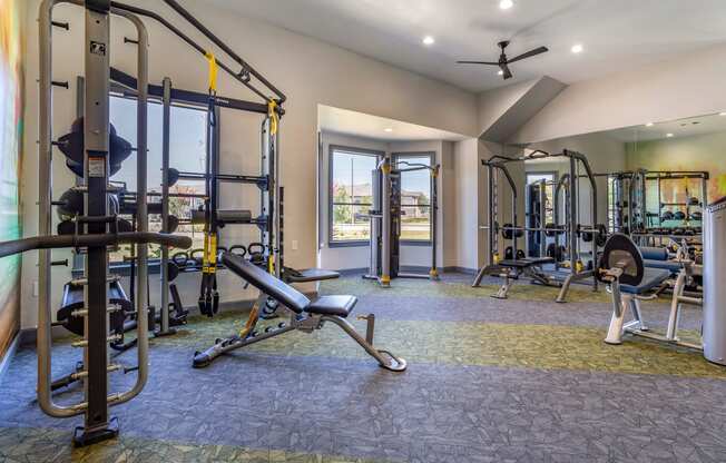 a gym with weights and cardio equipment and a window at Sladestone Shadow Creek, Texas, 77584