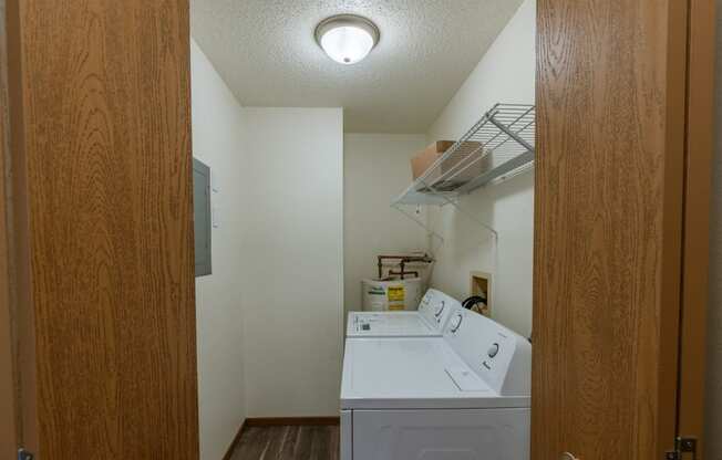 Grand Forks, ND Richfield Apartments. A laundry room with a washer and dryer in it