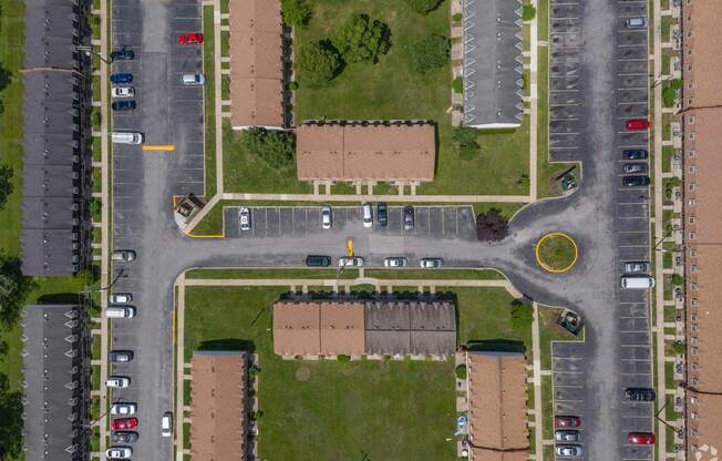 A parking lot with cars and a yellow circle on the pavement.
