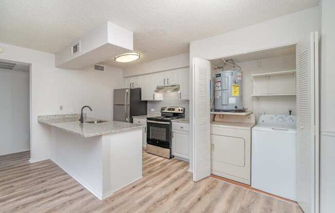 a kitchen with white appliances and a counter top