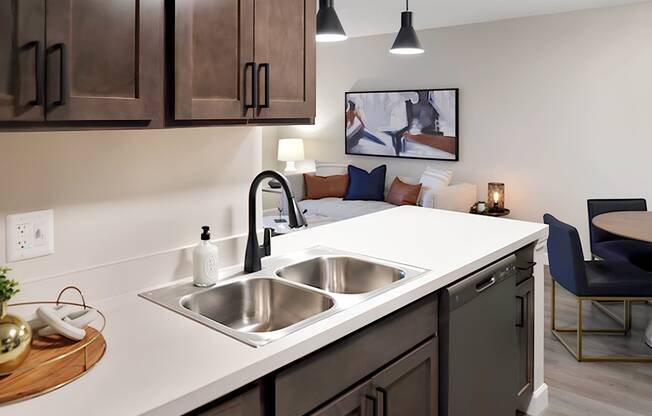 The Bennington apartment kitchen with wood cabinets and white countertops