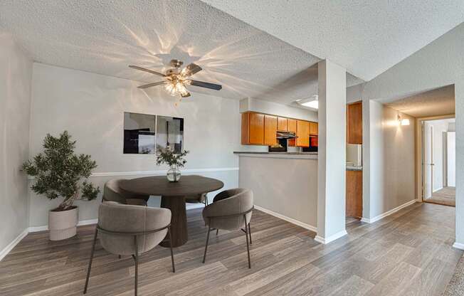 A dining room with a round table and chairs.