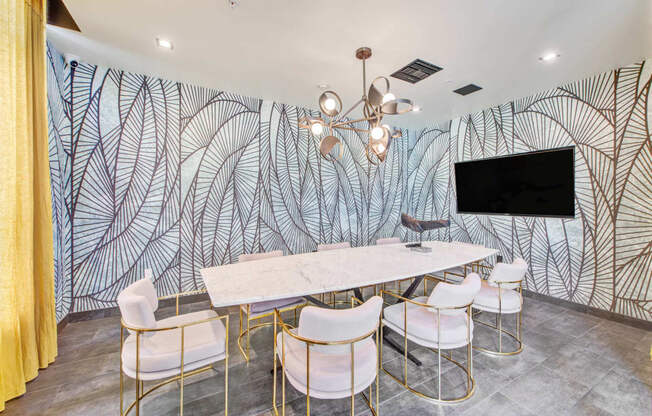 a dining room with a table and chairs and a wall mural