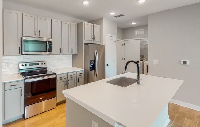 a kitchen with white cabinets and a white counter top